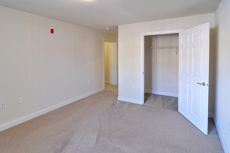a bedroom with a closet and an open door