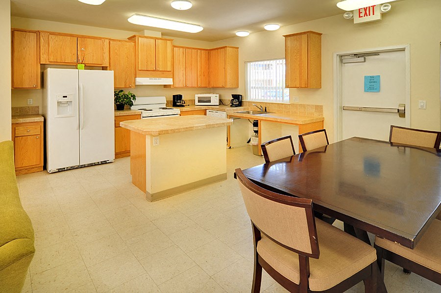 a kitchen with a table and chairs