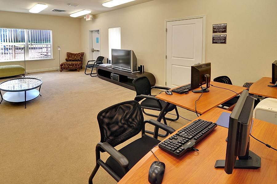 a room with two computers and two chairs