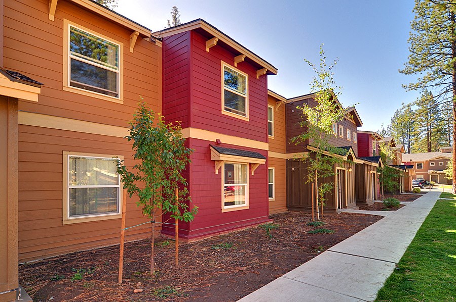 a row of houses with trees in front of them