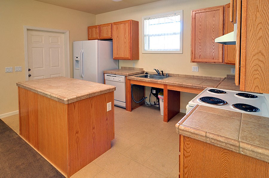 a kitchen with a stove and a refrigerator