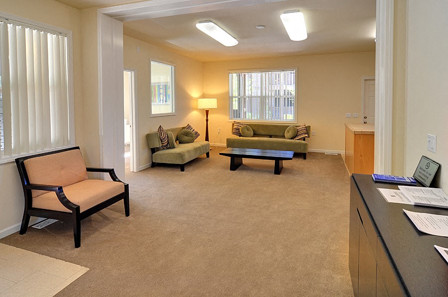 a living room with couches and chairs and a table