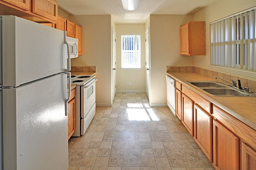 a kitchen with wooden cabinets and a white refrigerator
