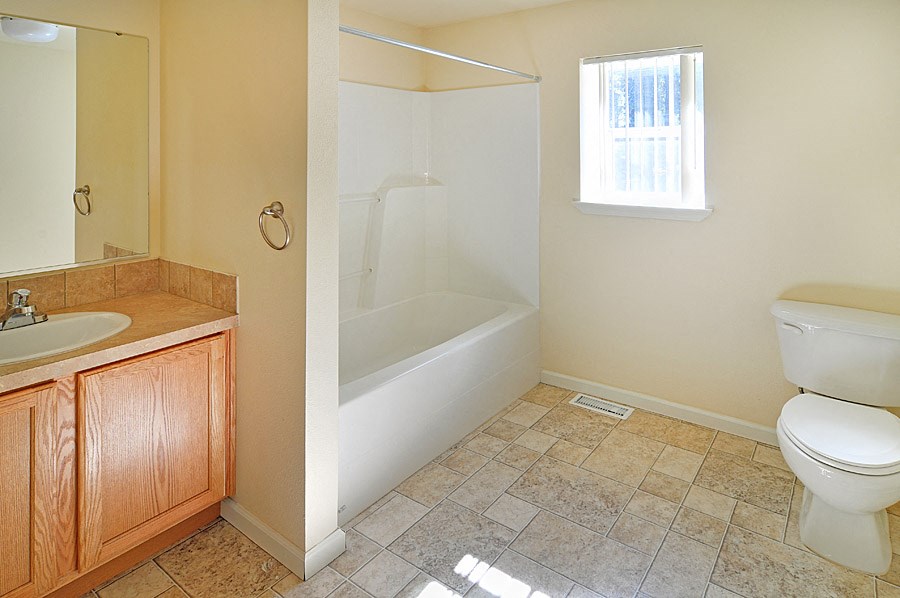 a small bathroom with a toilet and a window