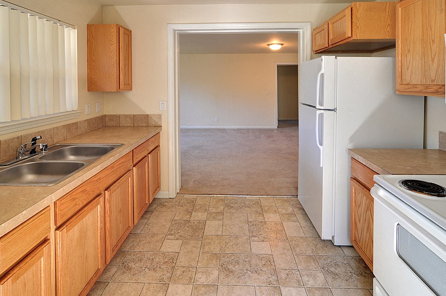 a kitchen with wooden cabinets and a white refrigerator