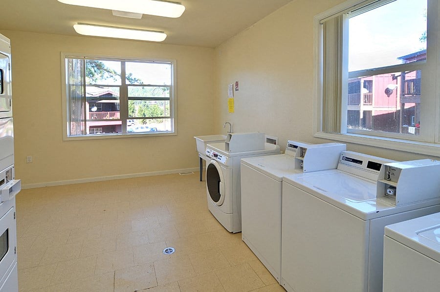 a laundry room with two washes and two dryers in it