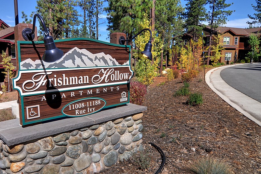 a sign apartments on the side of a road