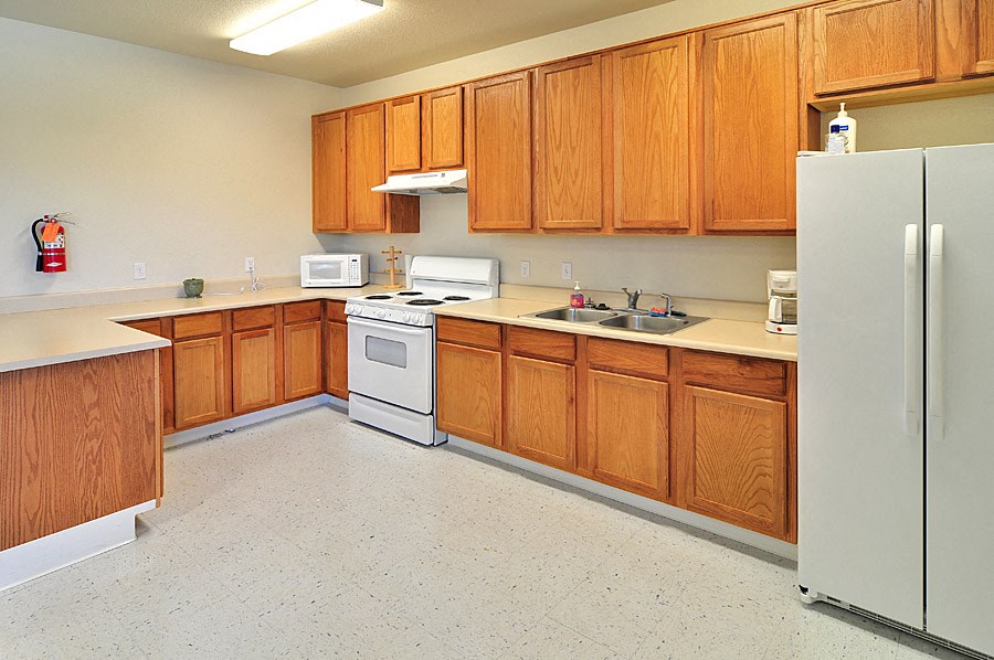 a kitchen with white appliances and wooden cabinets
