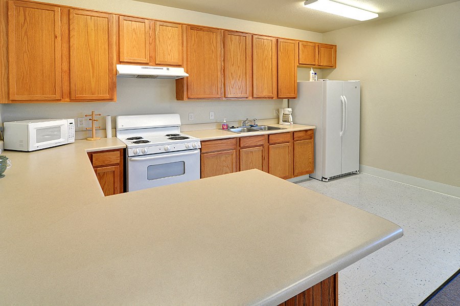 a kitchen with white appliances and wooden cabinets