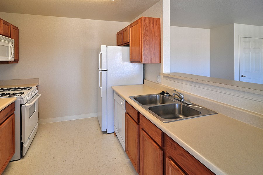 a kitchen with a sink and a refrigerator