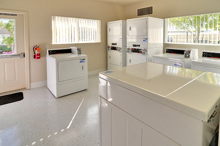 a kitchen with white appliances and white counter tops