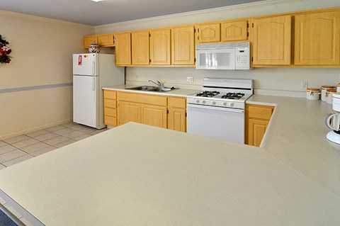 a kitchen with white appliances and wooden cabinets
