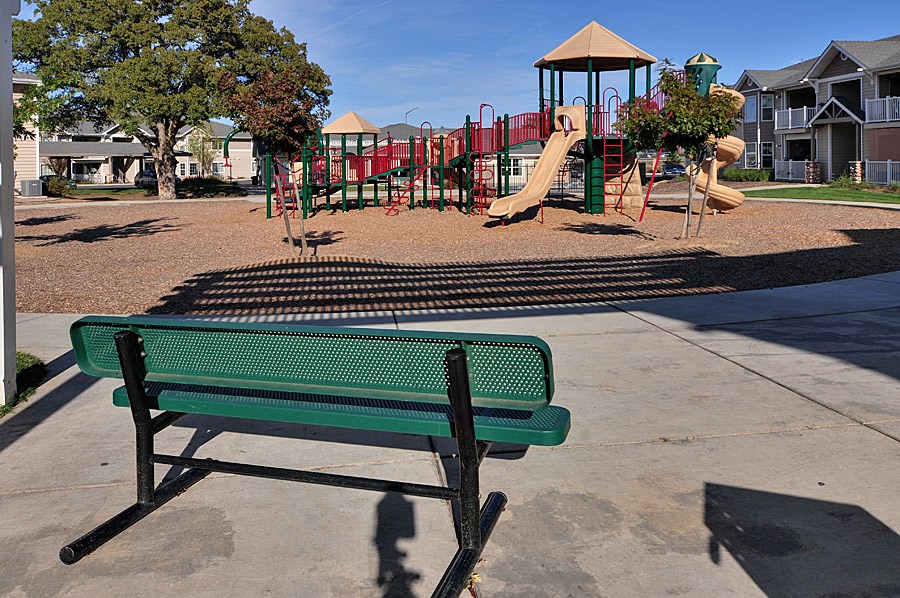 a park bench in front of a playground