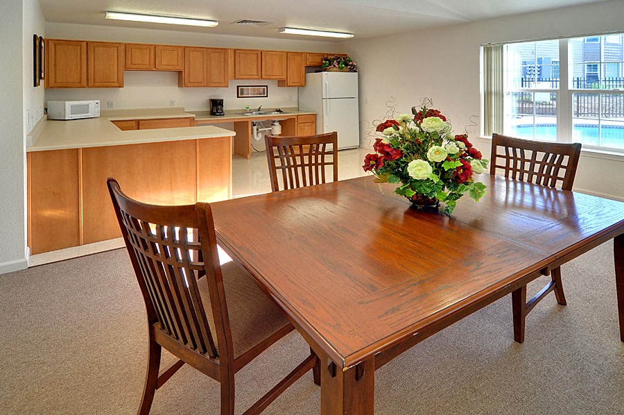 a dining room table with a vase of flowers on top of it