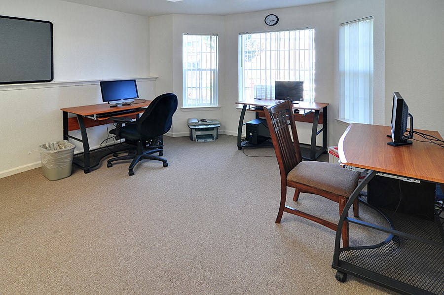 an office with two desks and two computers