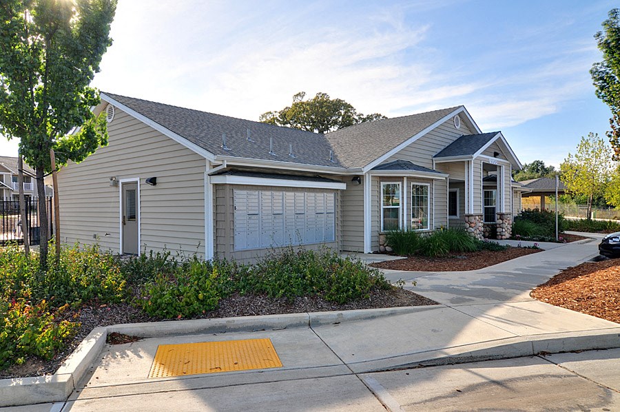 a white house with a gray roof and a white garage door