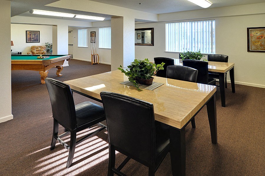 a conference room with a table and a pool table