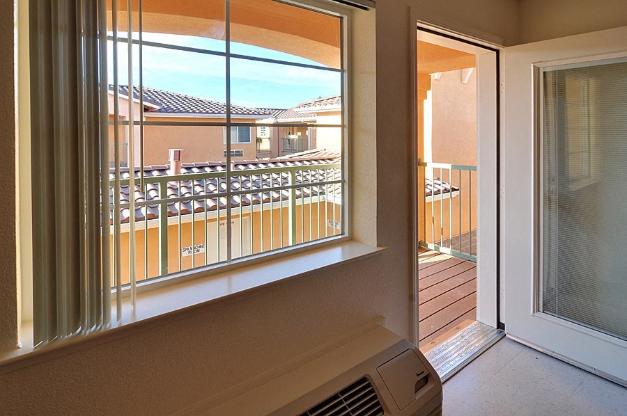 a view of the balcony from the living room of a condo