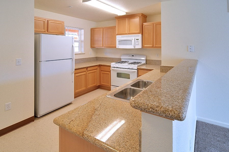 a kitchen with a counter top and a refrigerator