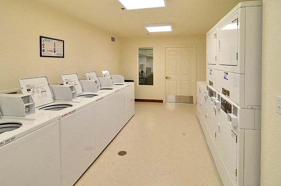 a kitchen with a row of white appliances and a door