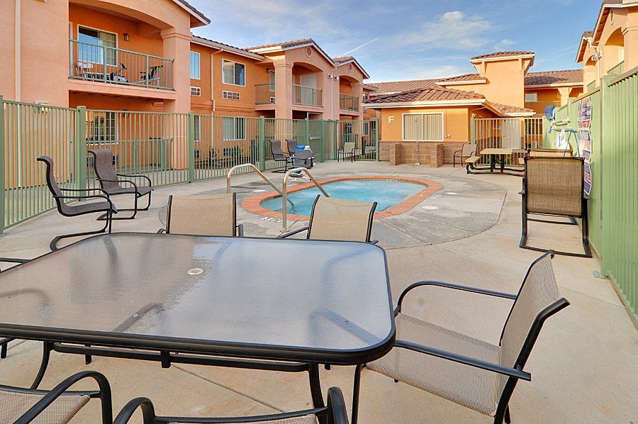our apartments have a large patio with tables and chairs