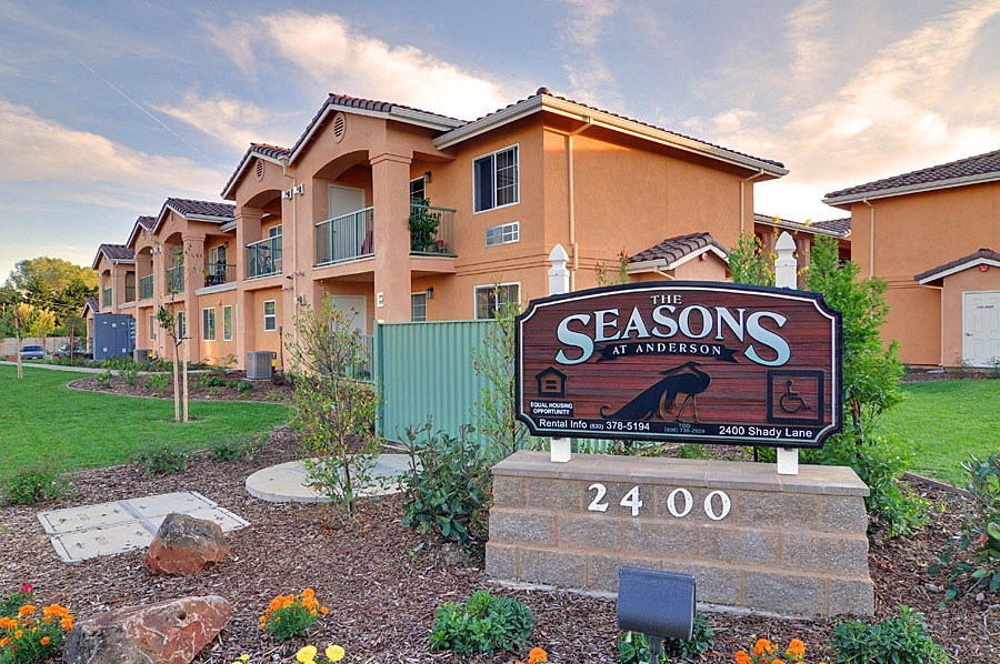 an image of the seasons in front of an apartment building