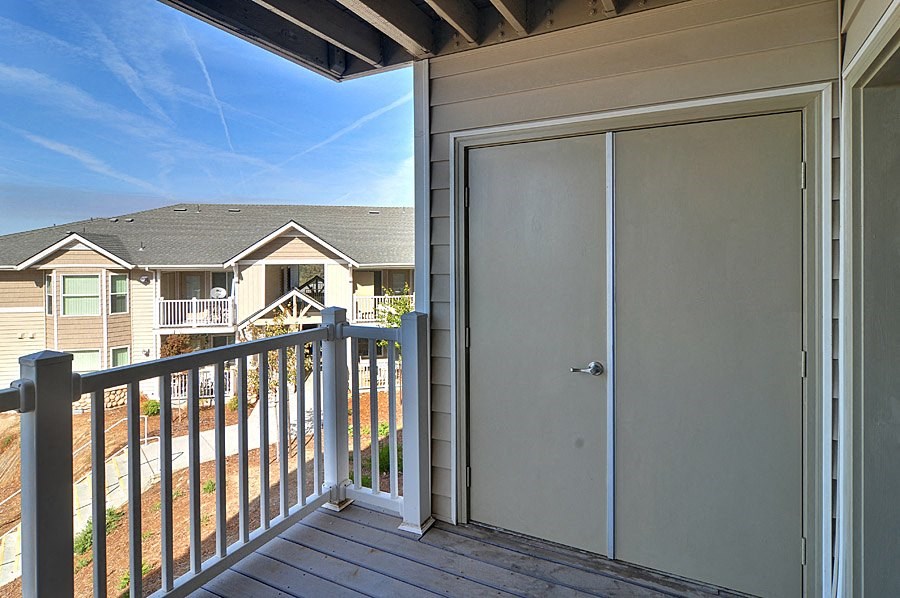 the view from the deck of a house with a sliding glass door