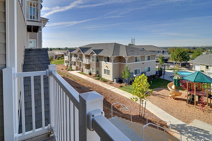 a view of apartments from a balcony with a pool