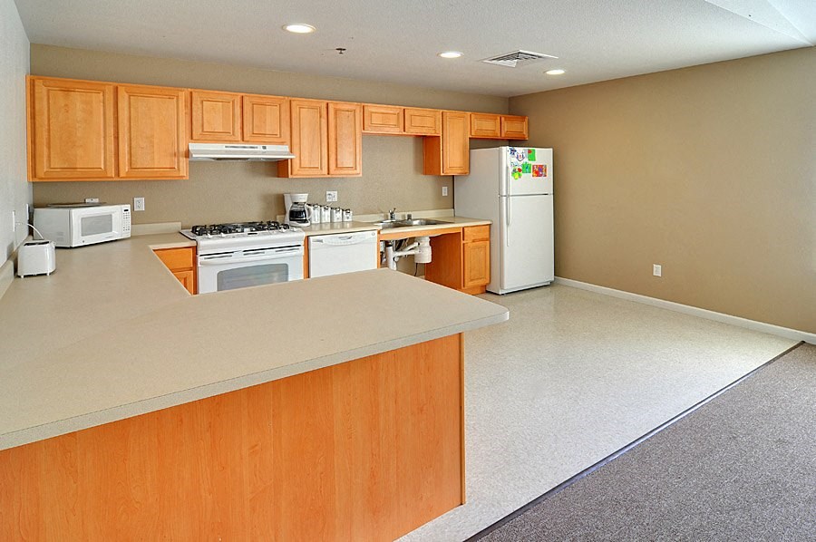 a kitchen with wooden cabinets and white appliances