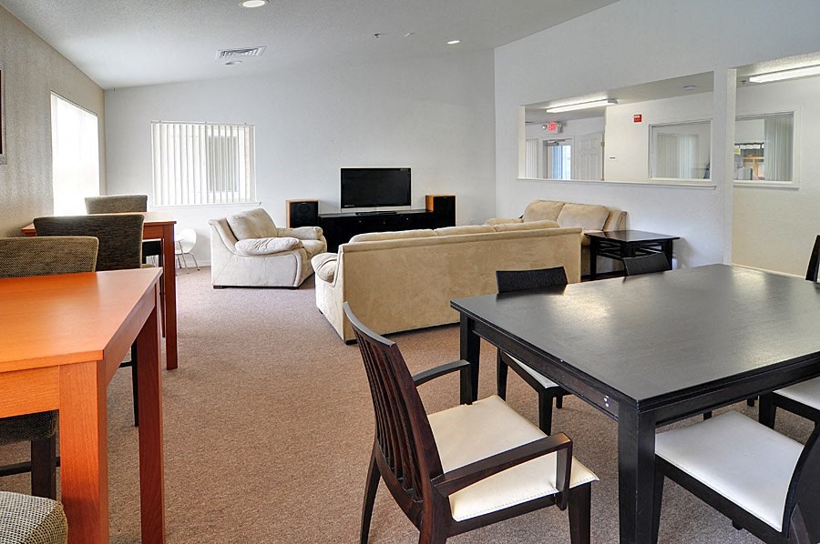 a living room with a table and chairs and a couch