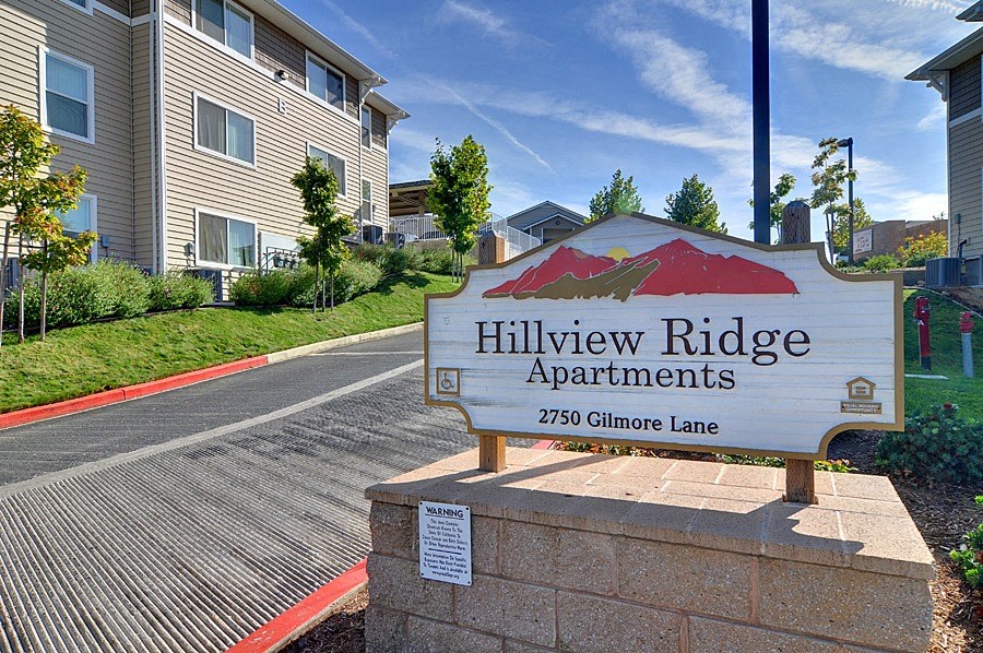 a sign for hillview ridge apartments in front of an apartment building
