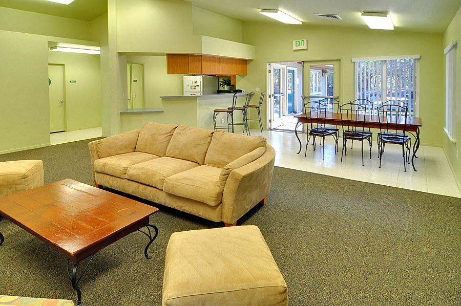 a living room with a couch a table and chairs