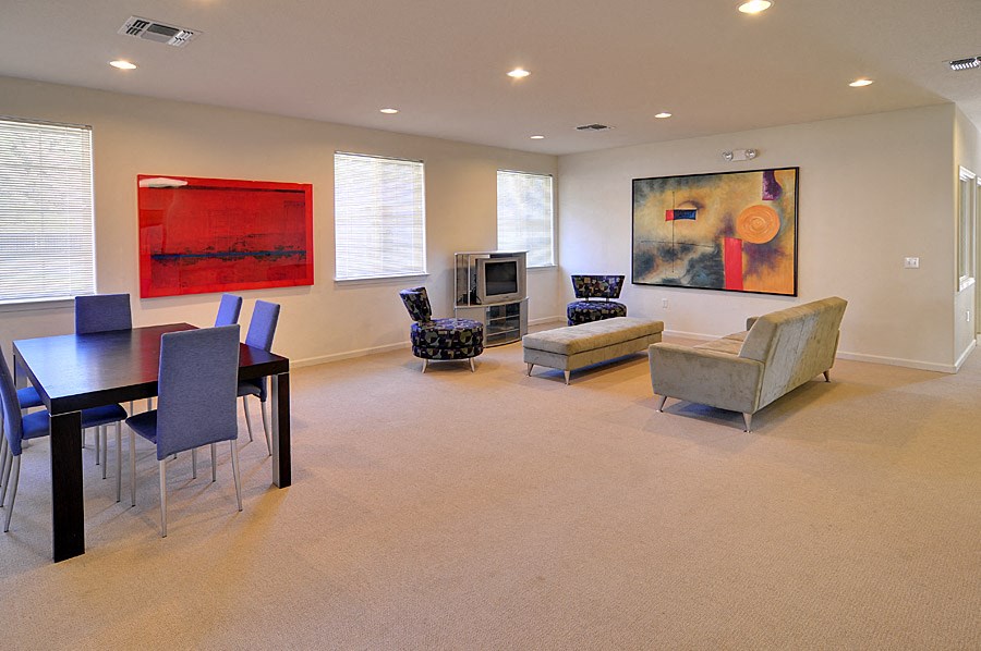 a living room with a table and chairs and a couch