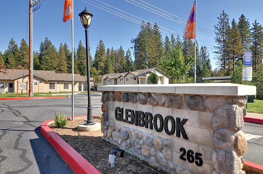 a stone sign that reads glenbrook 2665 at the corner of a street