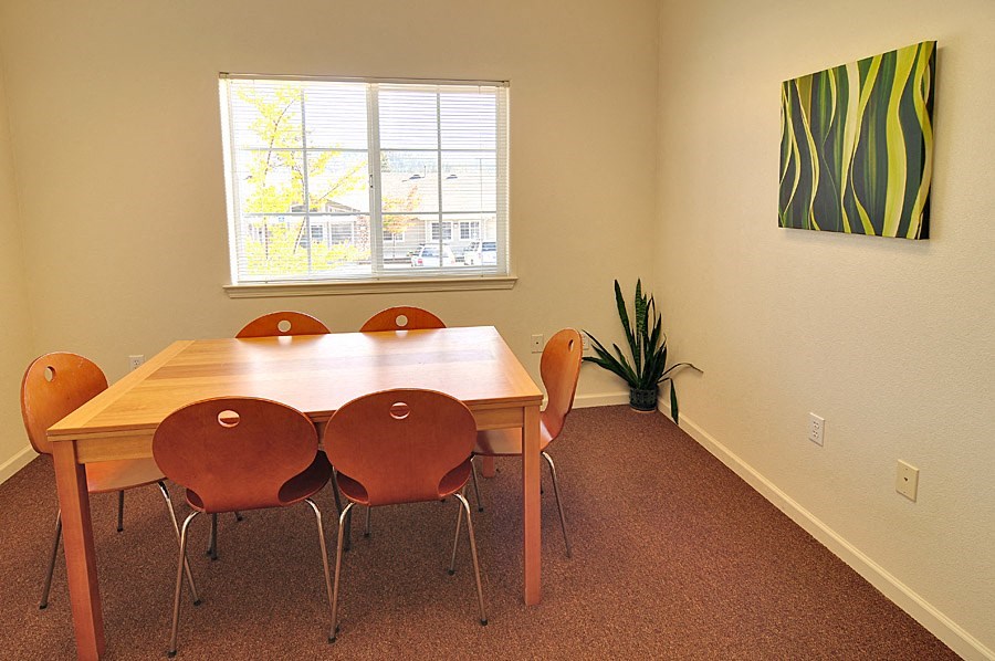 a conference room with a table and four chairs