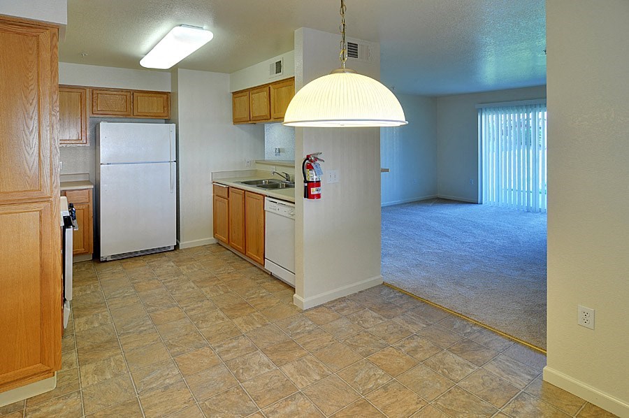 a kitchen with a white refrigerator freezer next to a stove top oven