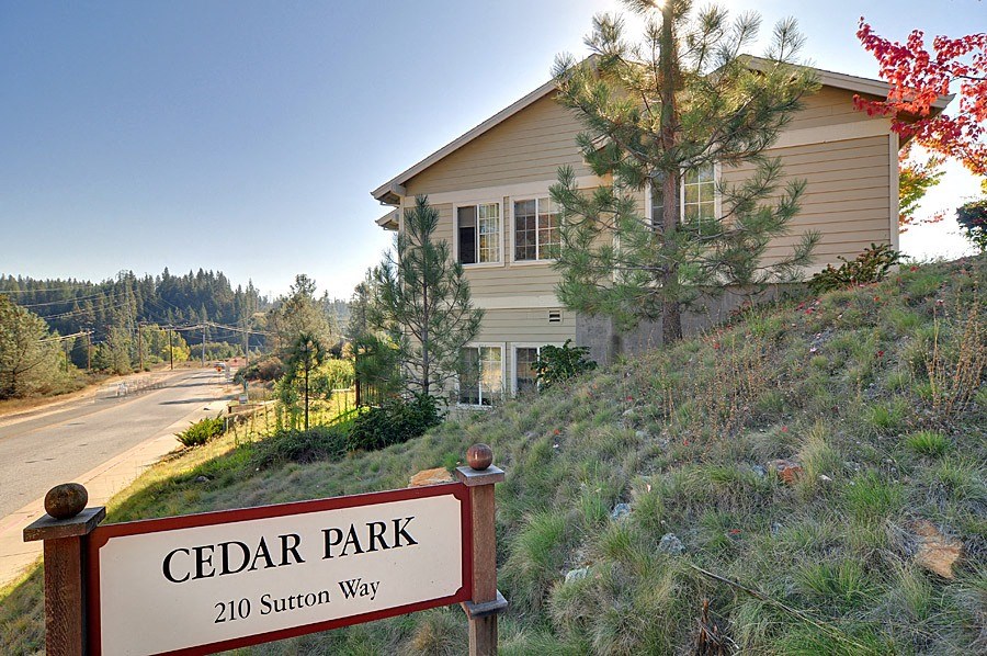 a house on a hill with a sign that reads cedar park