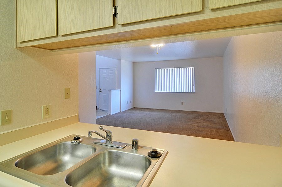 a kitchen with a sink and a window in the background