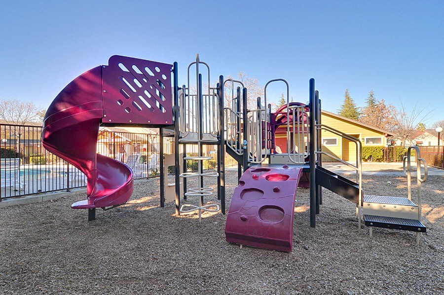 a playground with a slide and other equipment