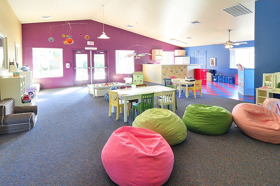 a childrens play room with bean bag chairs and tables