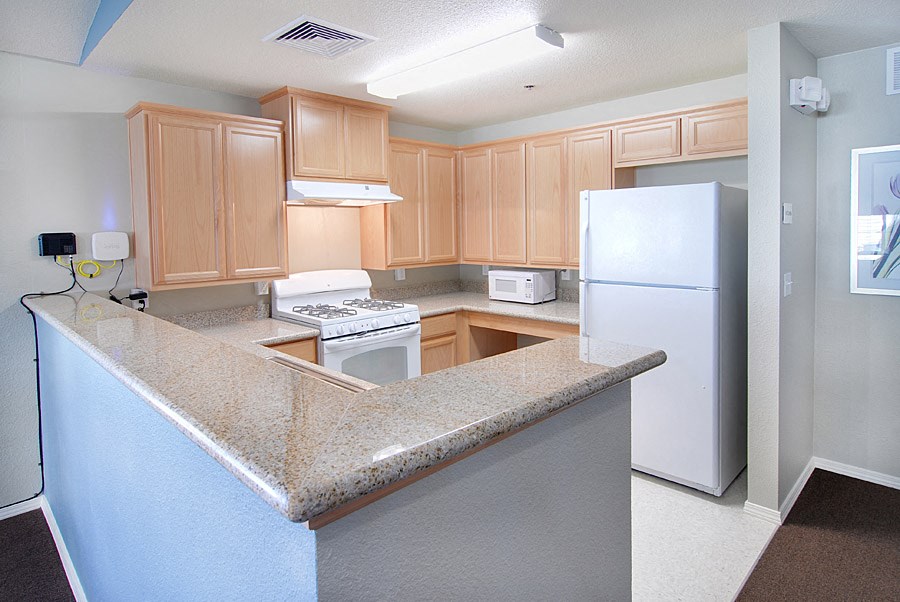 a kitchen with a counter top and a refrigerator