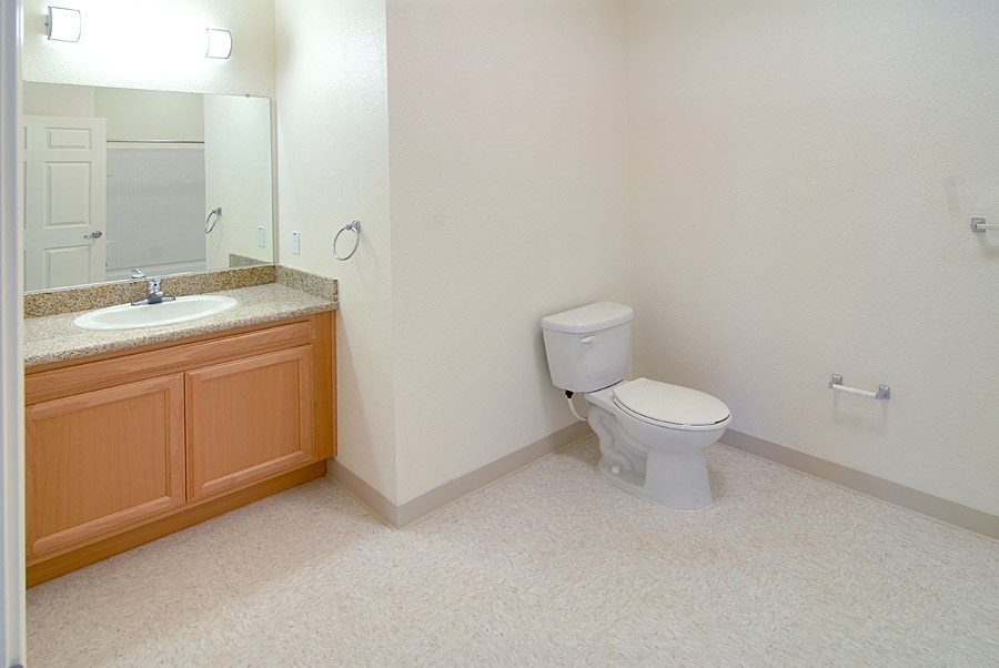 an empty bathroom with a toilet and a sink