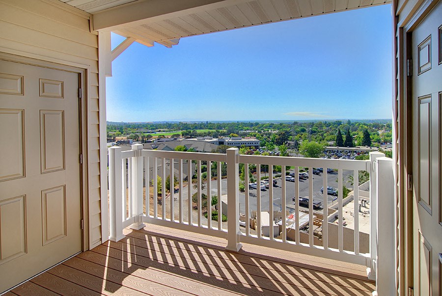 a view of the city from a balcony of a condo building