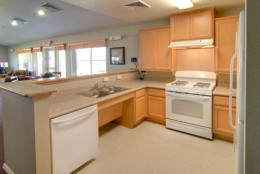 a kitchen with white appliances and wooden cabinets