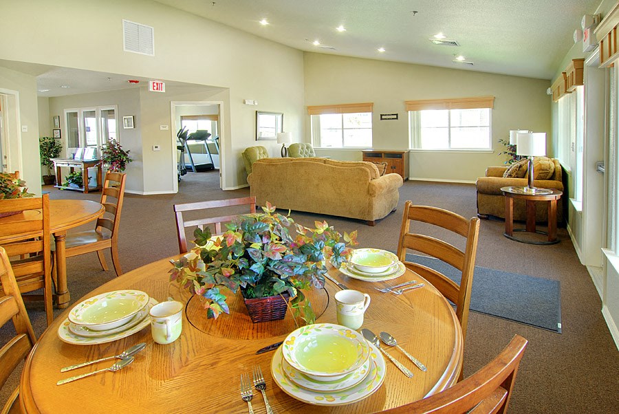 a dining room and living room with a table and chairs