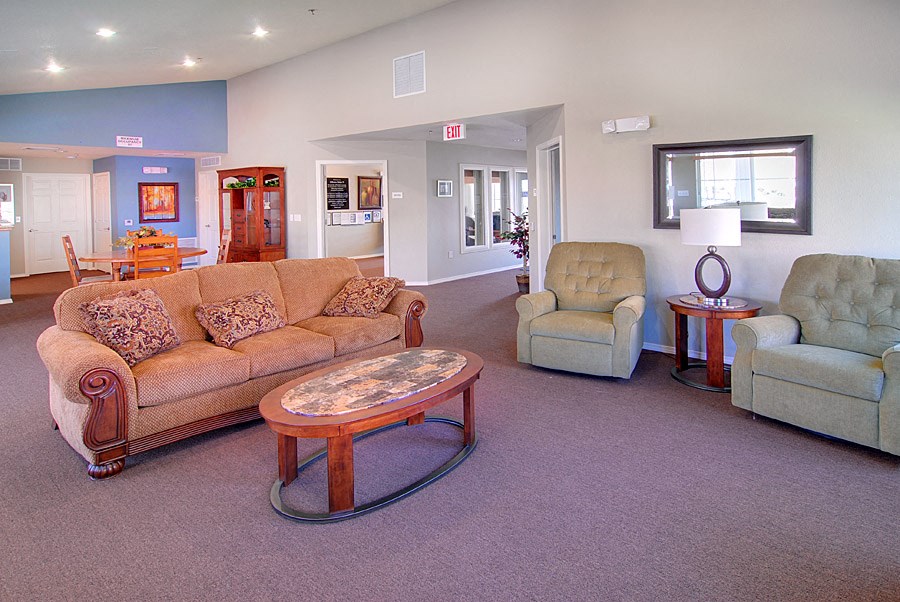 a living room with couches and chairs and a table