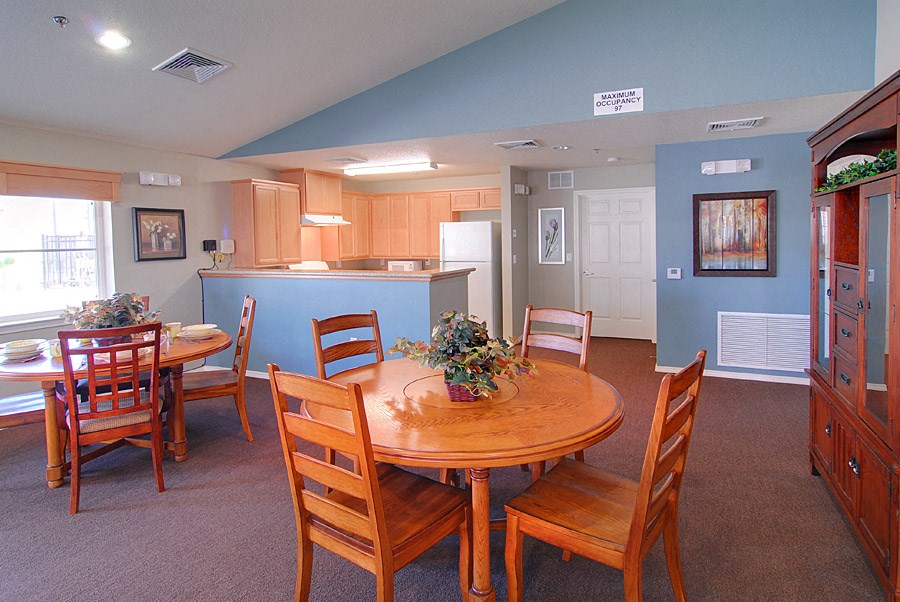 a dining room and kitchen with a table and chairs