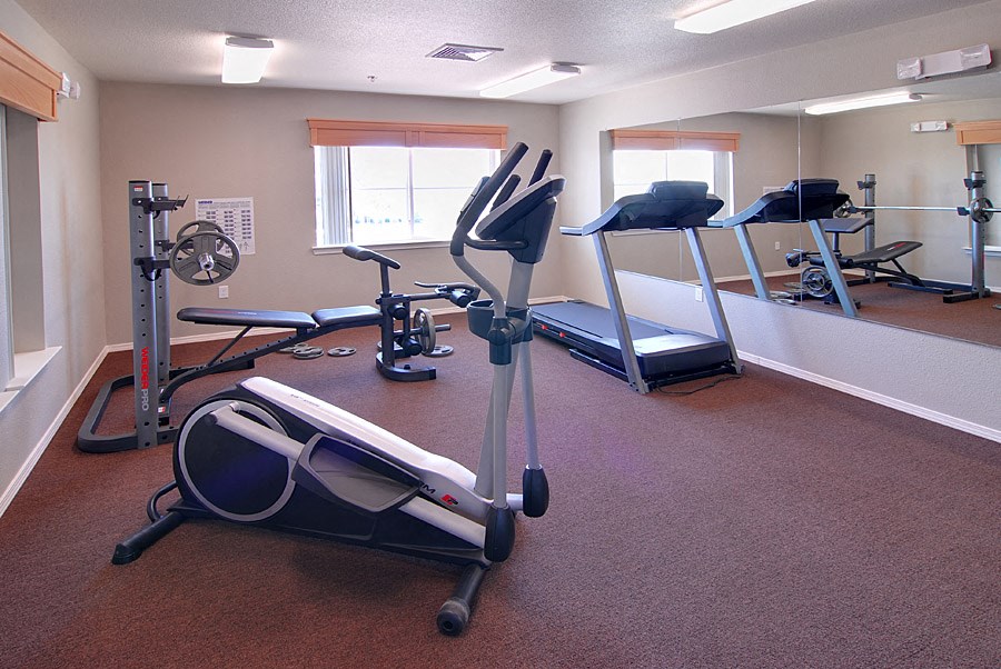 a gym with weights and exercise equipment in a room
