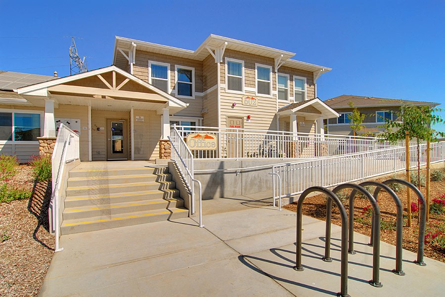 a pool with a fence in front of a house