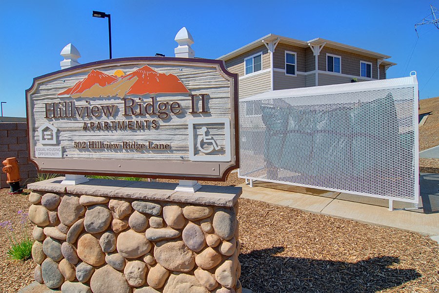 a sign for hillview ridge apartments in front of a building